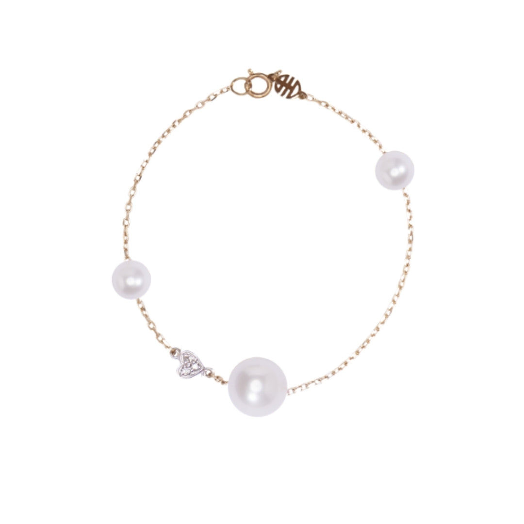 Bracciale con perle bianche e cuore di diamanti